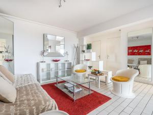 a living room with a couch and a glass table at Apartment Soleil Bleu-8 by Interhome in Canet-en-Roussillon