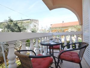 a patio with a table and chairs on a balcony at Apartment Mladen-2 by Interhome in Vodice