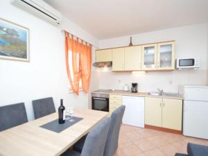 a kitchen and dining room with a table and chairs at Apartment Mladen-2 by Interhome in Vodice