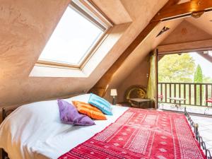 a bedroom with a bed with pillows and a window at Holiday Home Valhalla- chez Jules by Interhome in Planguenoual
