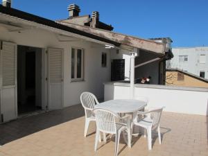 a white table and chairs on a patio at Apartment Bellavista-2 by Interhome in Cattolica