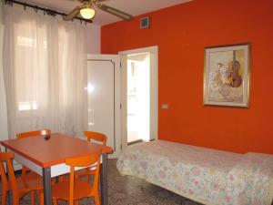 a bedroom with a table and a bed and a table and chairs at Apartment Bellavista 6 by Interhome in Cattolica +14 photos