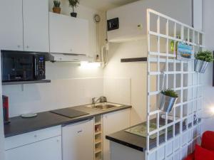 a small kitchen with a sink and a microwave at Apartment Les Trois Mousquetaires by Interhome in Saint-Palais-sur-Mer