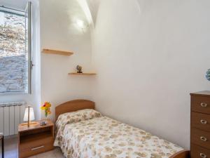 a small bedroom with a bed and a window at Holiday Home Le Antiche Volte - SLR215 by Interhome in Cipressa