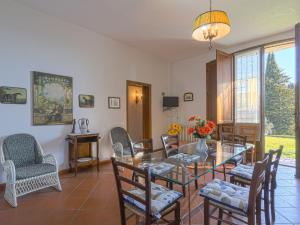 a dining room with a glass table and chairs at Holiday Home Podere Conte Francesco-La Palma by Interhome in Certaldo