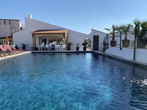 una gran piscina frente a una casa en Hôtel du Pont Blanc, en Saintes-Maries-de-la-Mer