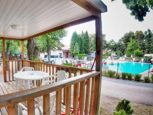 a wooden deck with a table and chairs and a pool at Holiday Home Sunset Terrace by Interhome in Prague