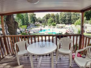 a table and chairs on a deck with a pool at Holiday Home Sunset Terrace by Interhome in Prague