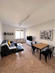a living room with a table and a couch at Apartament RZ in Gdynia