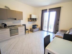 Una cocina y una sala de estar con una mesa y un sofá. en Apartment I Monili-3 by Interhome, en Moneglia