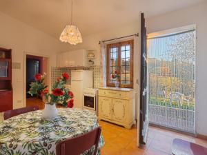 a kitchen with a table with a vase of flowers on it at Holiday Home Podere Conte Francesco-Carla by Interhome in Certaldo