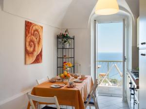 a dining room with a table with chairs and a window at Holiday Home Francesca - SLR212 by Interhome in Cipressa