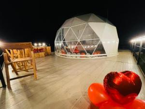 ein Zimmer mit einer Glaskuppel mit einem Herz auf dem Boden in der Unterkunft Stellarium Glamping in Murillo