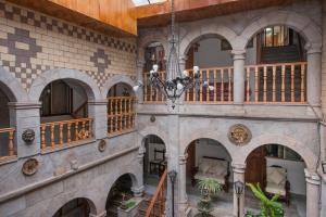 a large building with arches and a chandelier at Ayenda Casa Escondida San Cristóbal Premium in Cusco