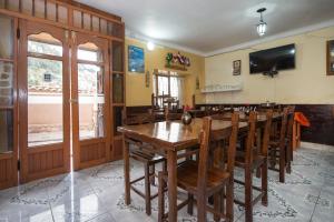 a dining room with a wooden table and chairs at Ayenda Casa Escondida San Cristóbal Premium in Cusco