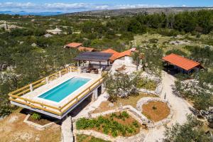 an aerial view of a house with a swimming pool at Holliday Home "Maslinada" in Milna