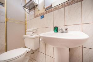 a bathroom with a white sink and a toilet at Ayenda Casa Escondida San Cristóbal Premium in Cusco +40 photos