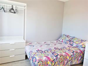 a bedroom with a bed and a dresser at Apartment Les Romarins by Interhome in Narbonne-Plage