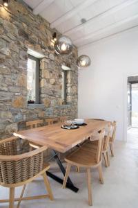 a dining room with a wooden table and chairs at Dreamy Cycladic Luxury Summer Villa 1 in Serifos Chora