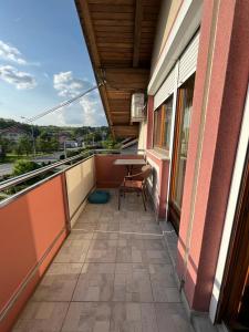 a balcony of a building with a table on it at Apartmani M&D in Laktaši