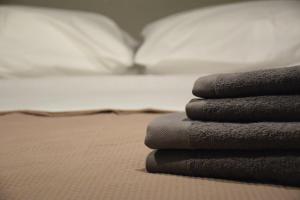 a pile of towels sitting on top of a bed at Villa Prasini in Agios Sostis +33 photos