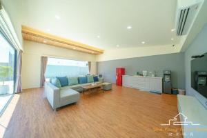 a living room with a couch and a table at 台南民宿 拾光旅宿-世平二館-預訂後聯繫才會保留 in Tainan