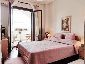 a bedroom with a large bed and a large window at Christie's Boutique by Corfuescapes in Alepou