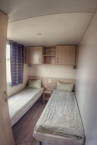 a small room with two beds and a window at Holiday Home Prima Plus by Interhome in Prague