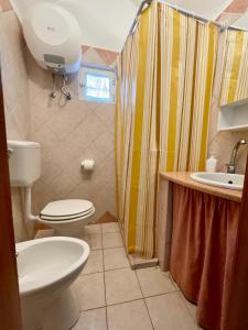 a bathroom with a toilet and a sink at Pizzo Casale in Vico del Gargano