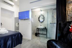 a bathroom with a shower and a sink and a bed at Marie Rooms Centar Split in Split