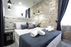 a bedroom with a large bed with towels on it at Marie Rooms Centar Split in Split