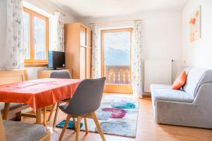 a living room with a table and a couch at Pürstinghof in Flachau