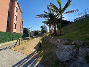 a street with trees on the side of a building at Arbidel, apartamento con piscina en Llanes VUT-2758-AS in Llanes