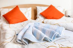 a bed with two pillows and a blanket on it at Pürstinghof in Flachau