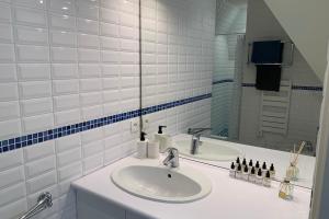 a white bathroom with a sink and a mirror at Nice 41 M With Balcony Near The Beach in Deauville