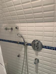 a bathroom with a shower with a shower head at Nice 41 M With Balcony Near The Beach in Deauville