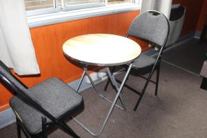 a table and two chairs sitting next to a window at Hostal Capricho de Carlitos in Valdivia