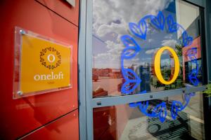 a window with a o sign in a store at Oneloft Hotel in Obernai +6 photos