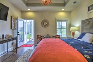 a bedroom with a large bed with a red blanket at 3 Mi to Fenwick Island Beach Luxe Bungalow in Peppers Landing