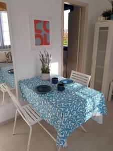 a dining room table with a blue and white table cloth at Casa Ble - Izla Homes in Skala