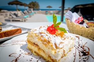 a piece of cake on a plate next to a pool at En Plo Boutique Suites in Oia