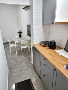 a kitchen with a table and a table and chairs at Sima Suite in Ashdod