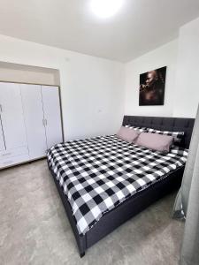 a bedroom with a black and white checkered bed at Sima Suite in Ashdod