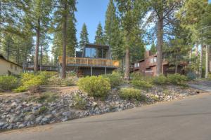a house with a deck in the woods at Dollar Point in Tahoe City