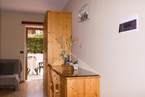 a room with a wooden cabinet and a table at hotel Parco Pineta in Cavareno