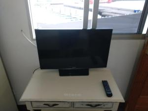a television sitting on a table with a remote control at Apartamento Puerto Estaca 3 in Puerto de la Estaca +11 photos