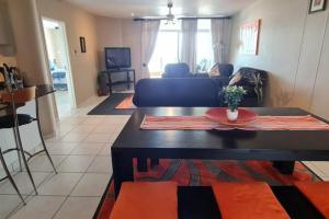 a living room with a table and a couch at Santorini Unit R in Margate