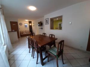 a dining room with a wooden table and chairs at aux hirondelles du lac in Le Mêle-sur-Sarthe