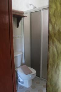 a bathroom with a toilet with a towel on it at Hotel El Moro in Puerto Morelos