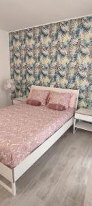 a bedroom with a bed with pink pillows on it at Ideal holiday apartment in the south of Tenerife in Costa Del Silencio